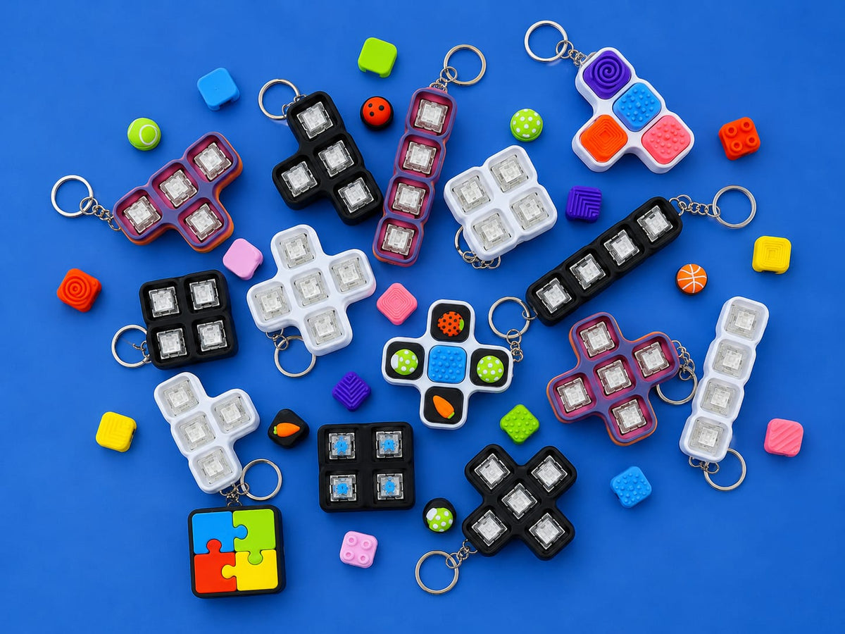 Finished Build Your Own Clicker kits in different shapes and colours with loose caps