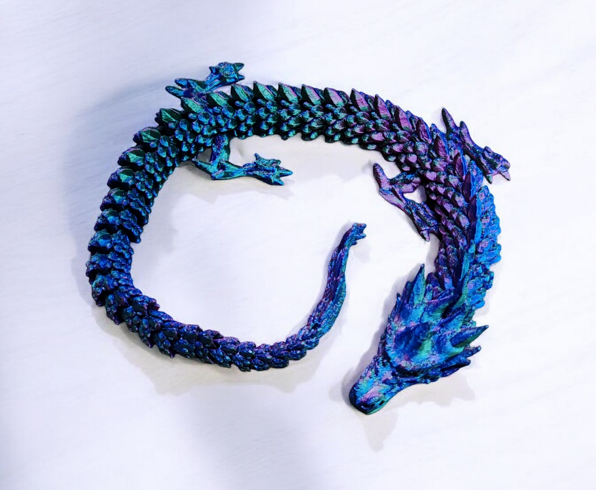 Small rainbow colored dragon with articulated wings and body