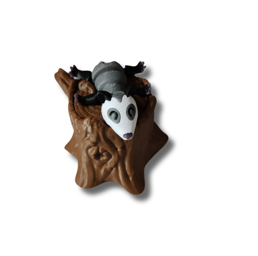 Gray possum collectible on tree stump base
