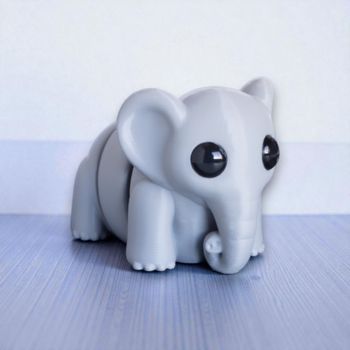 Gray flexible elephant figurine with moveable trunk