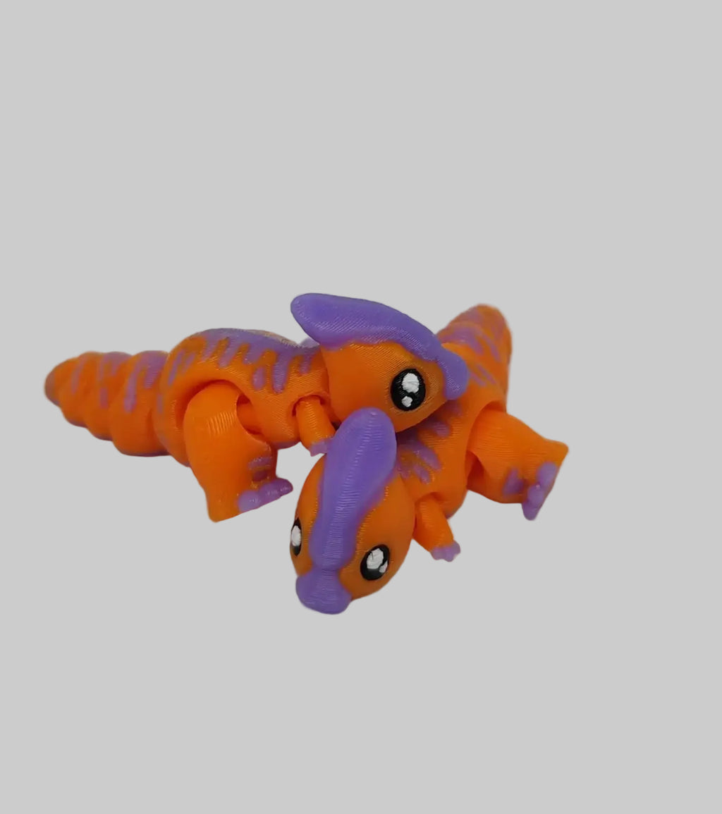 Close-up of articulated Parasaur dinosaur toy. Toy figure of a creature with orange and purple colors on a white background