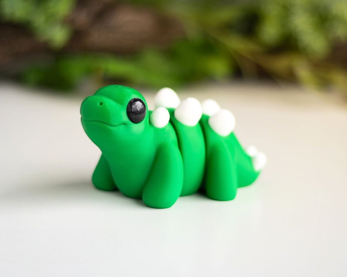 Green flexible Stegosaurus dinosaur figurine with back plates