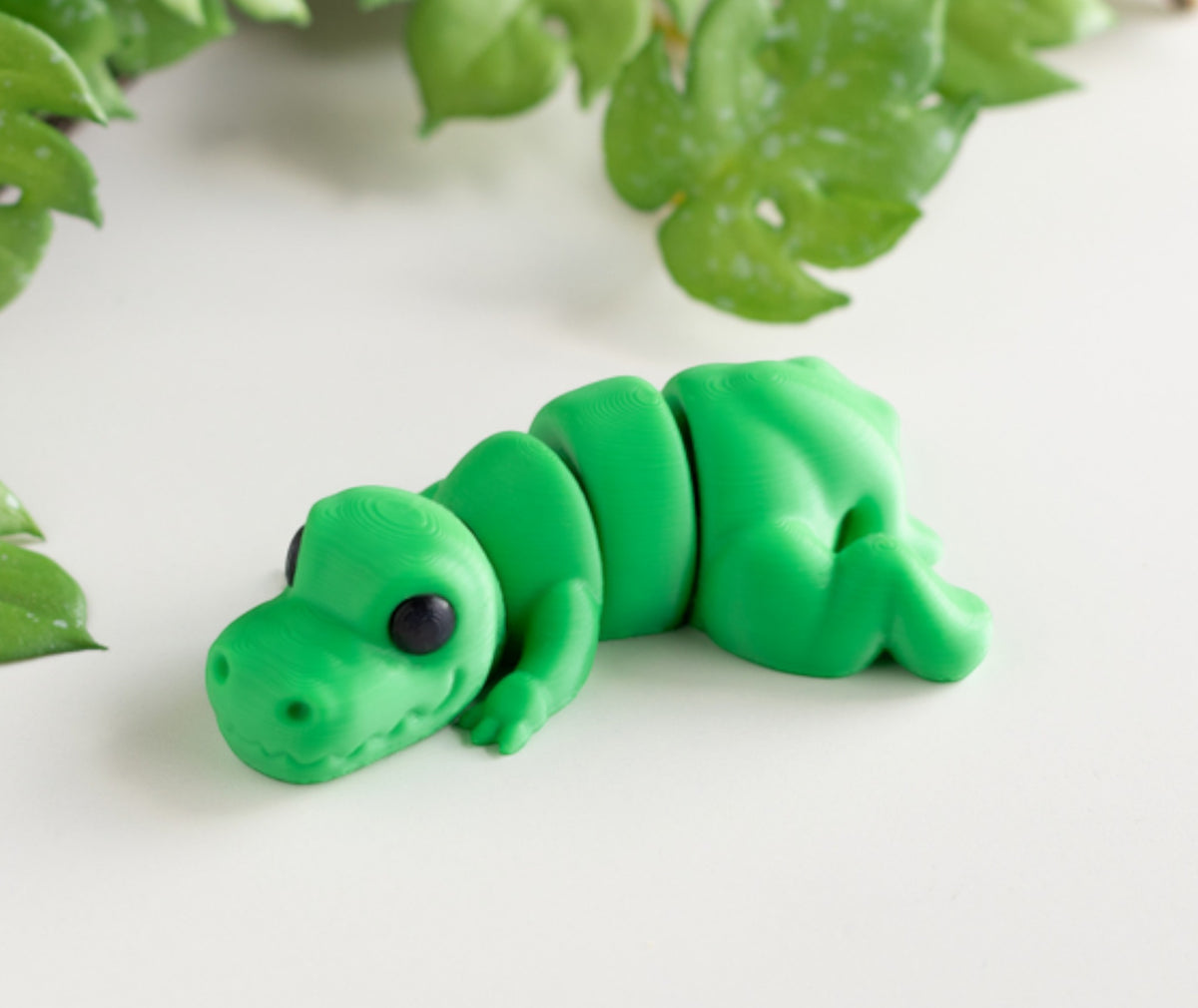 Green flexible T-Rex dinosaur figurine with articulated jaw